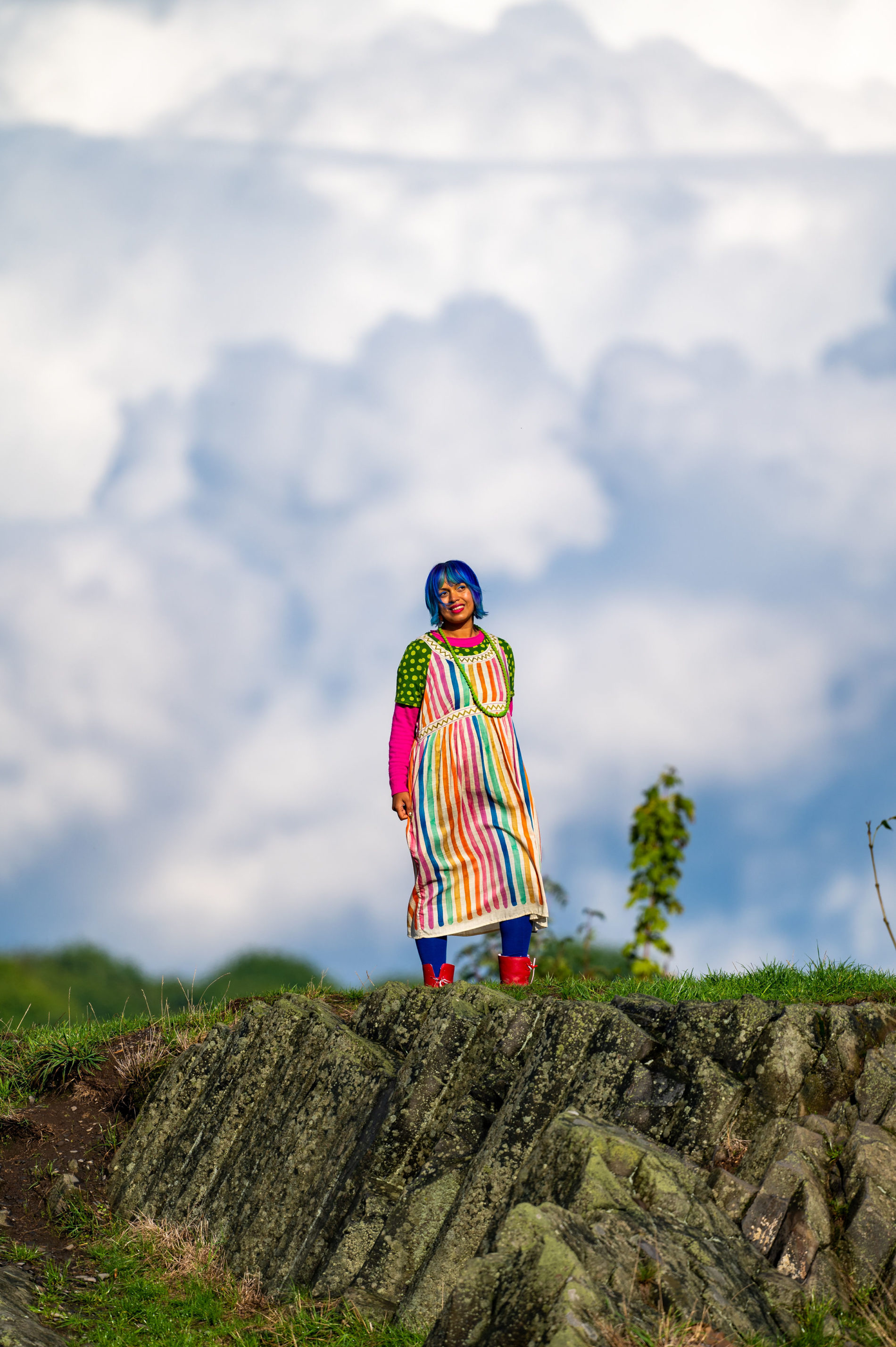 momtaz wearing rainbow dress surrounded by clouds standing in Panska Skala