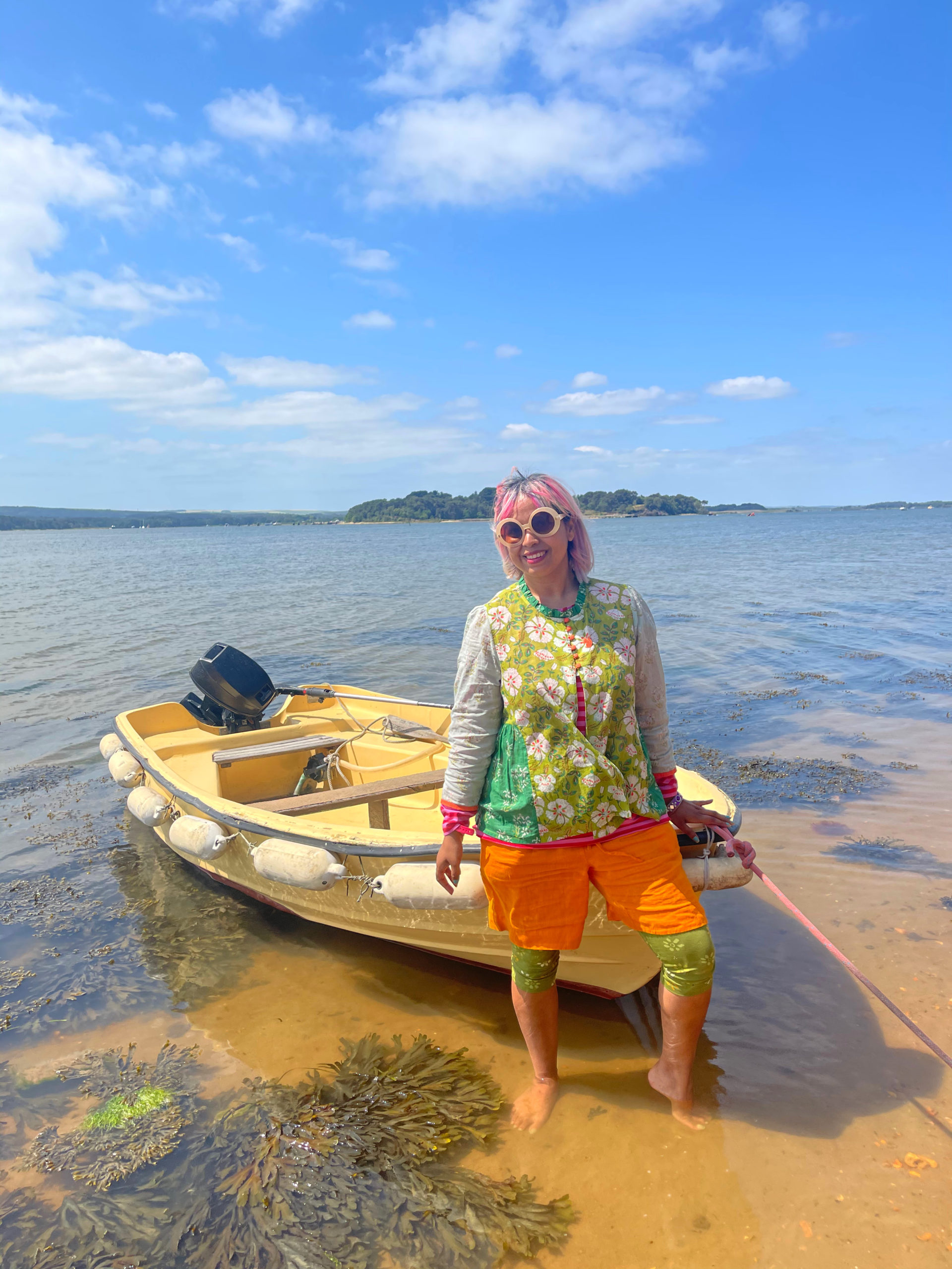 the beach at brownsea island with a boat