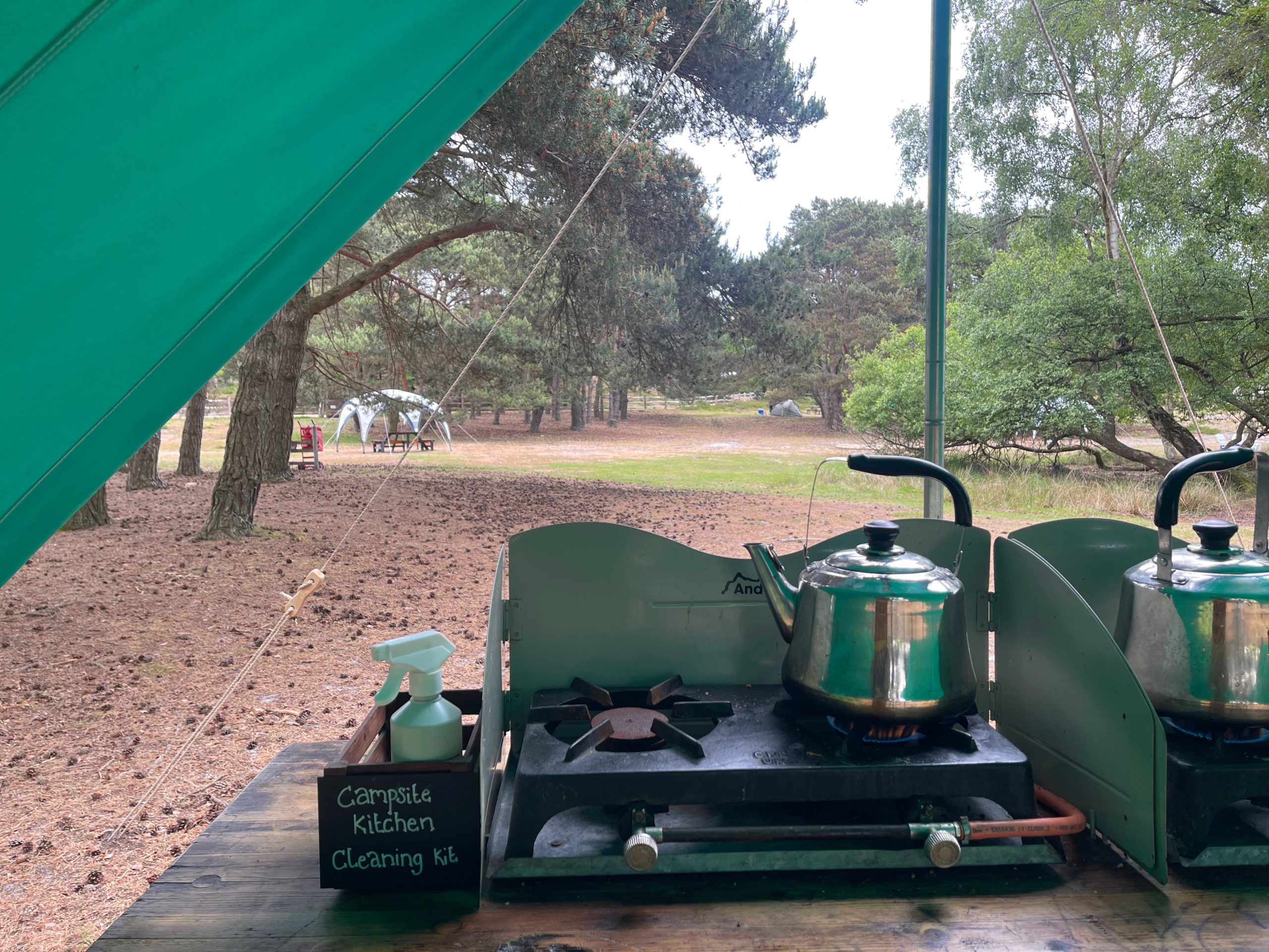 photo shots the camping kitchen set up with a kettle on the boil