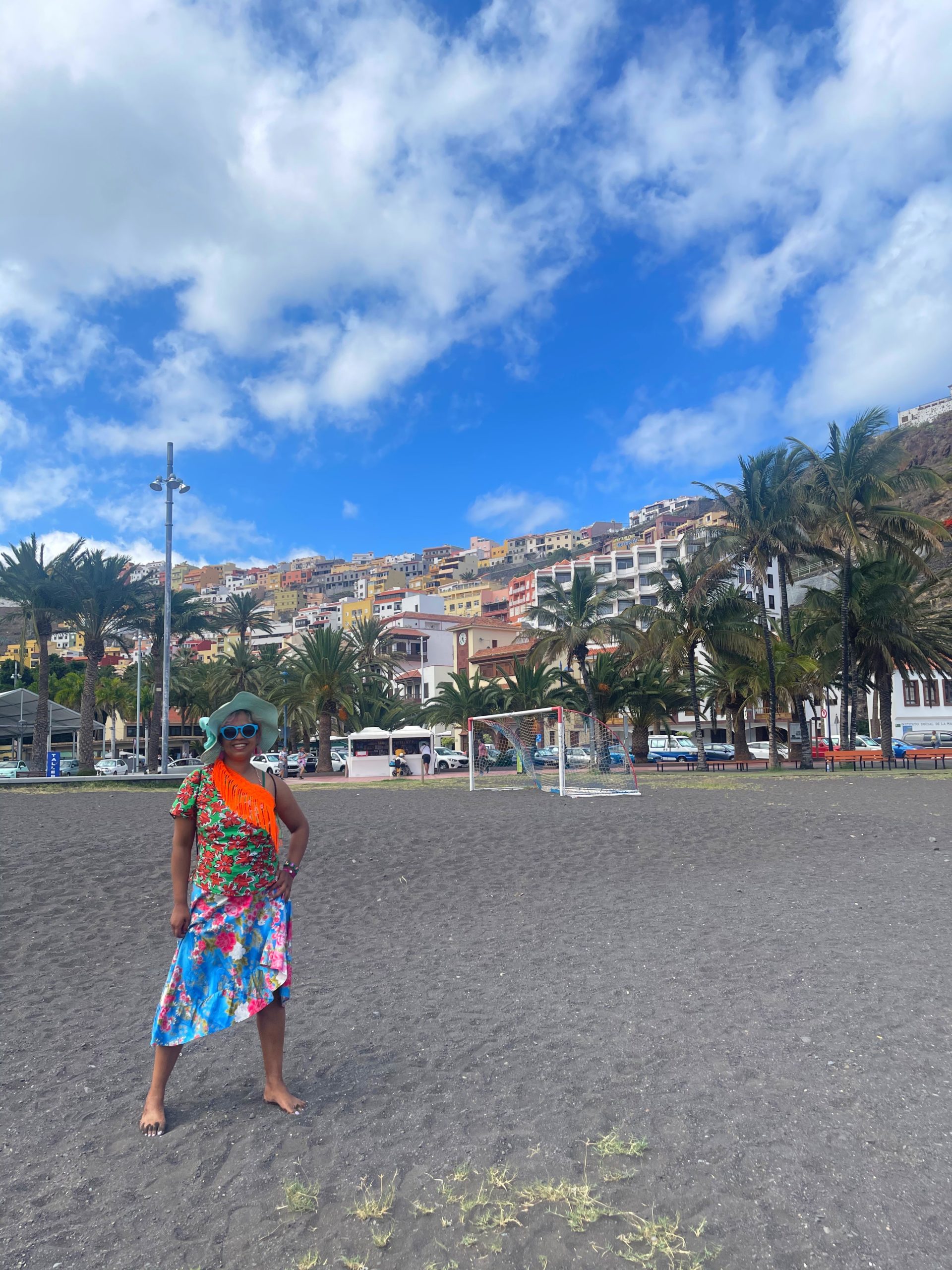 black sand beach at la gomera with colourful buildings in the background