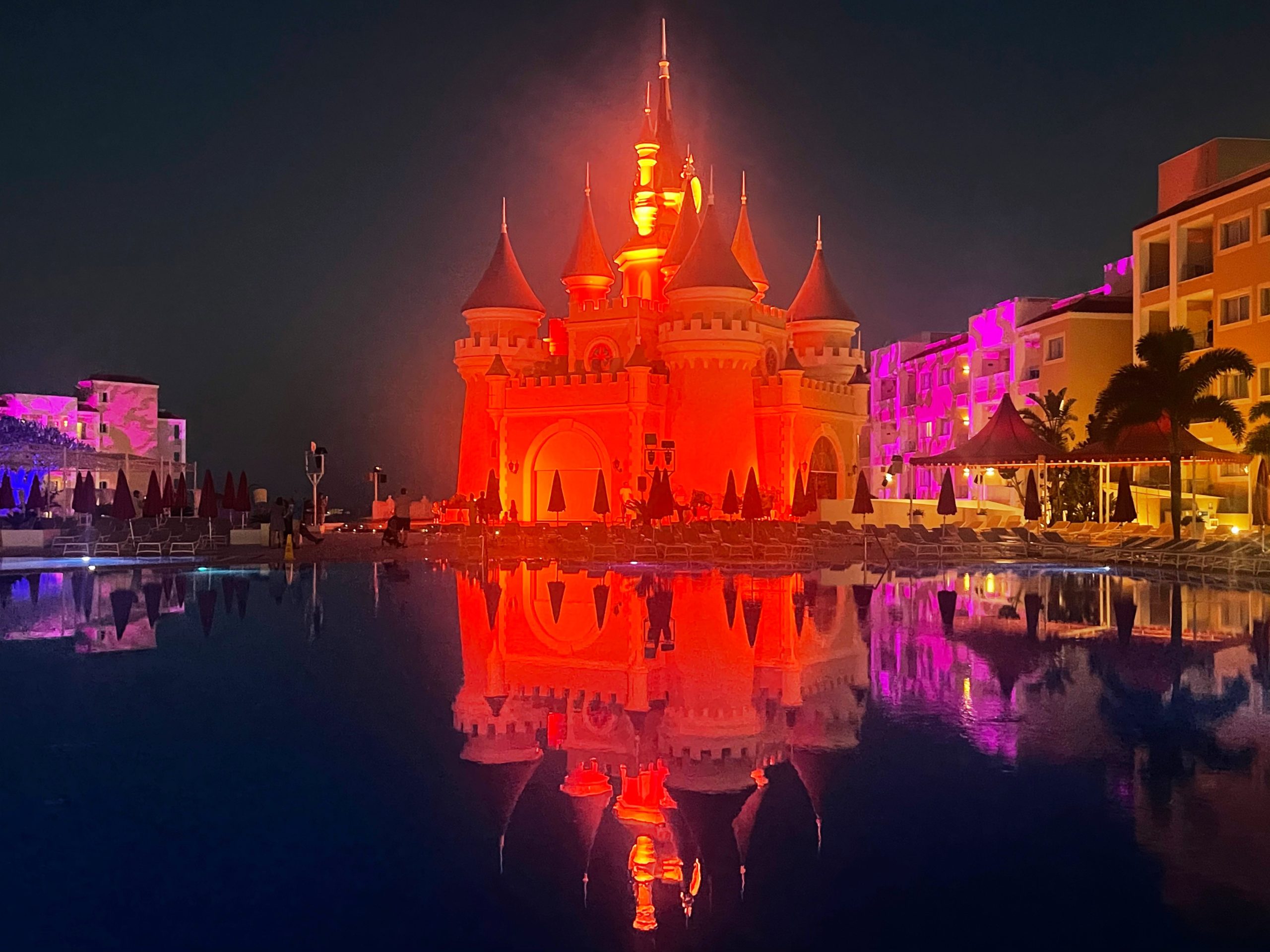 Castle at hotel lit up at nigh in red lights