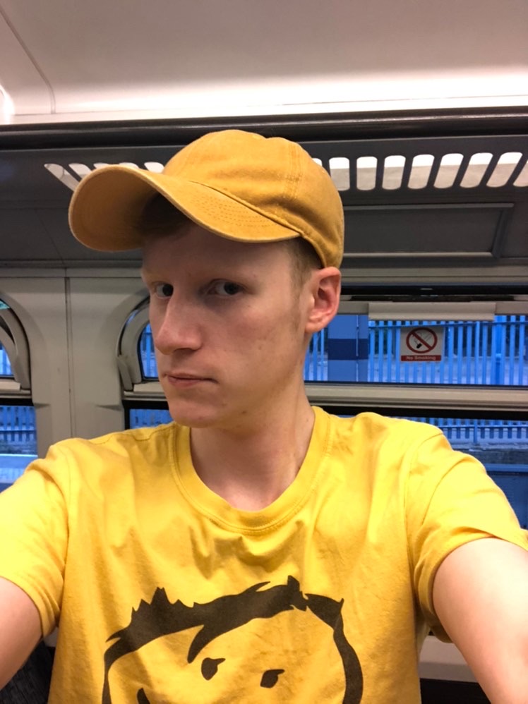 Photo of Do wearing  a yellow cap and t shirt