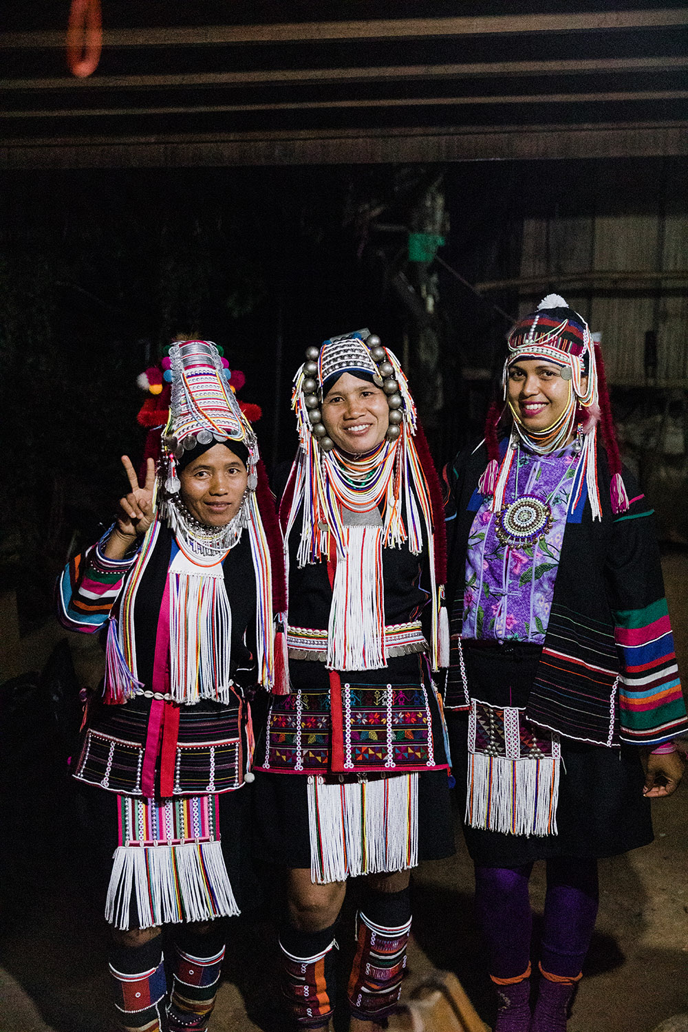 two akha women wearing traditional outfits and me with them who has been dress