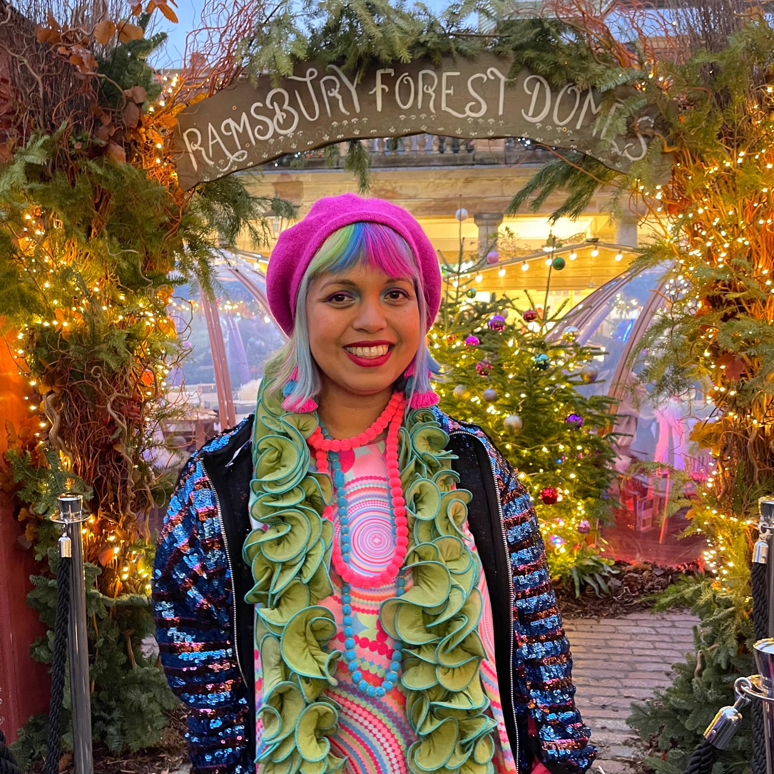 Momtaz standing infront of seated domes in covent garden 