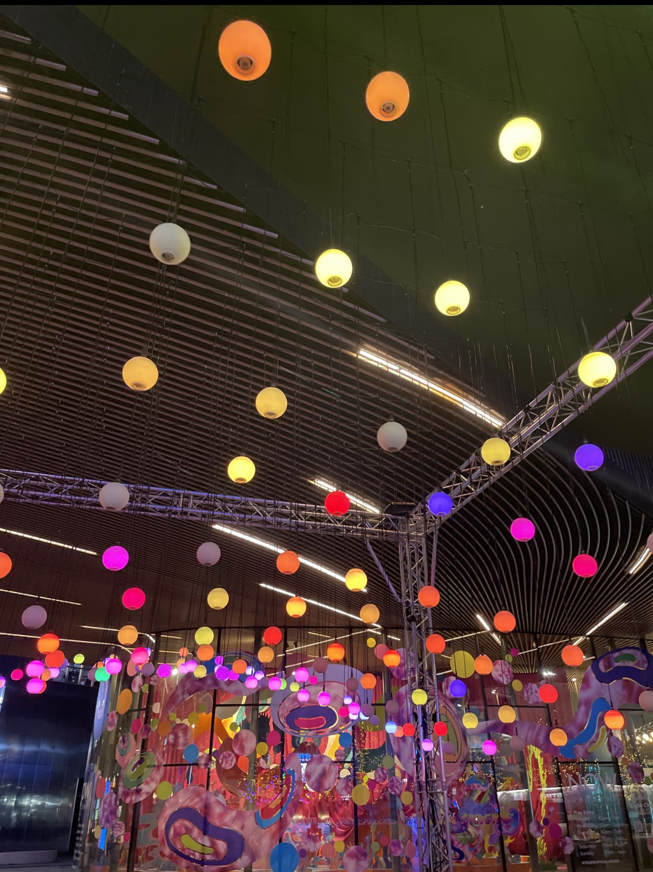 hanging rainbow balls outside the now gallery in greenwich peninsula