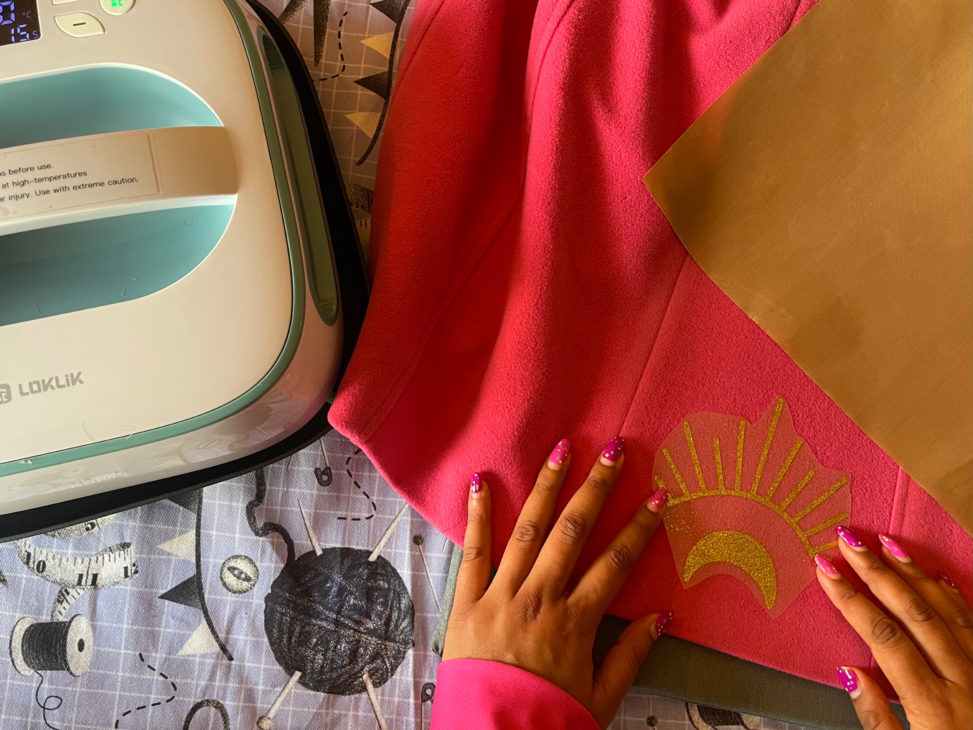 using a heat press to customise a coat with cosmic icons