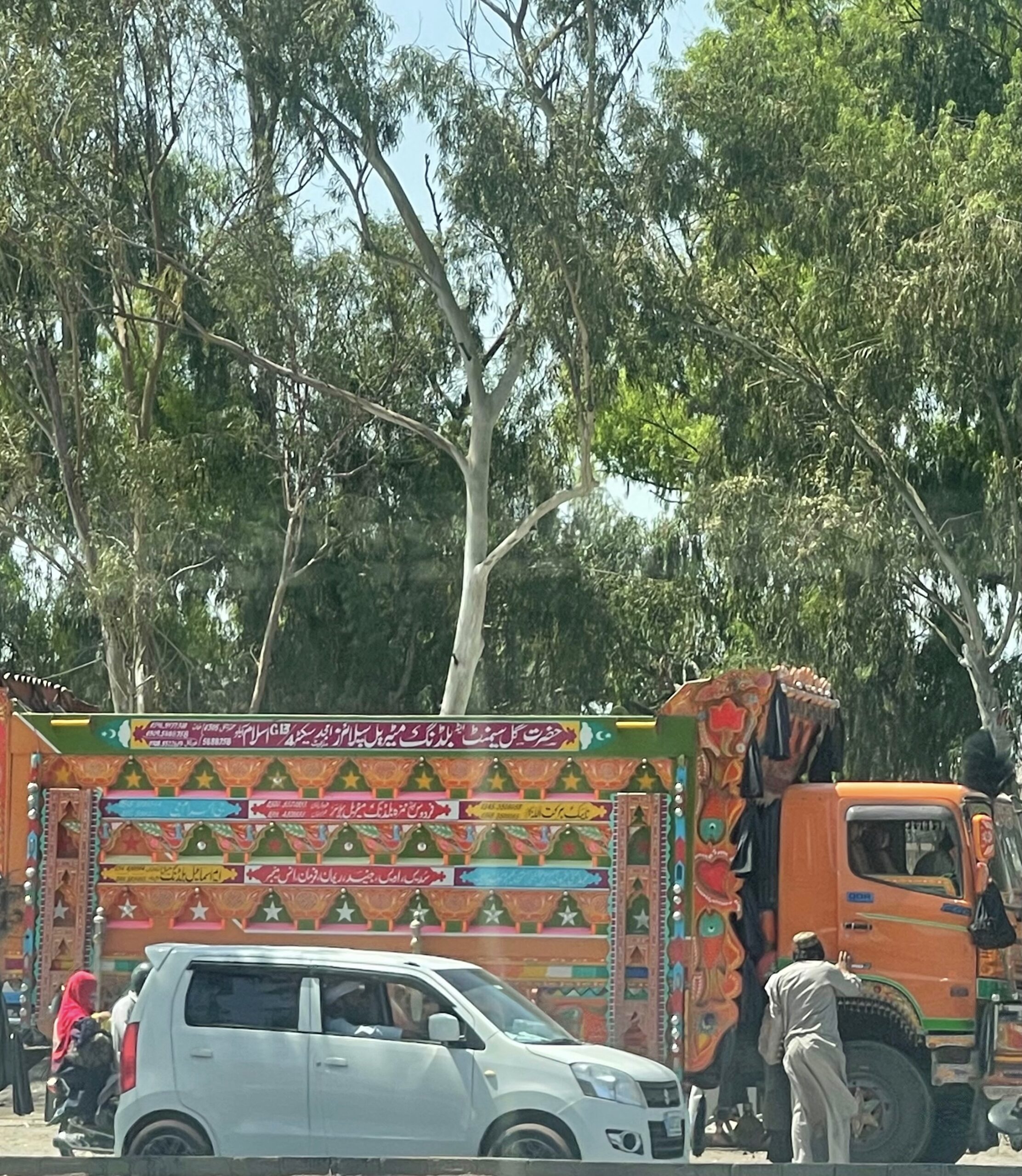 side video of a colourful orange truck on the road