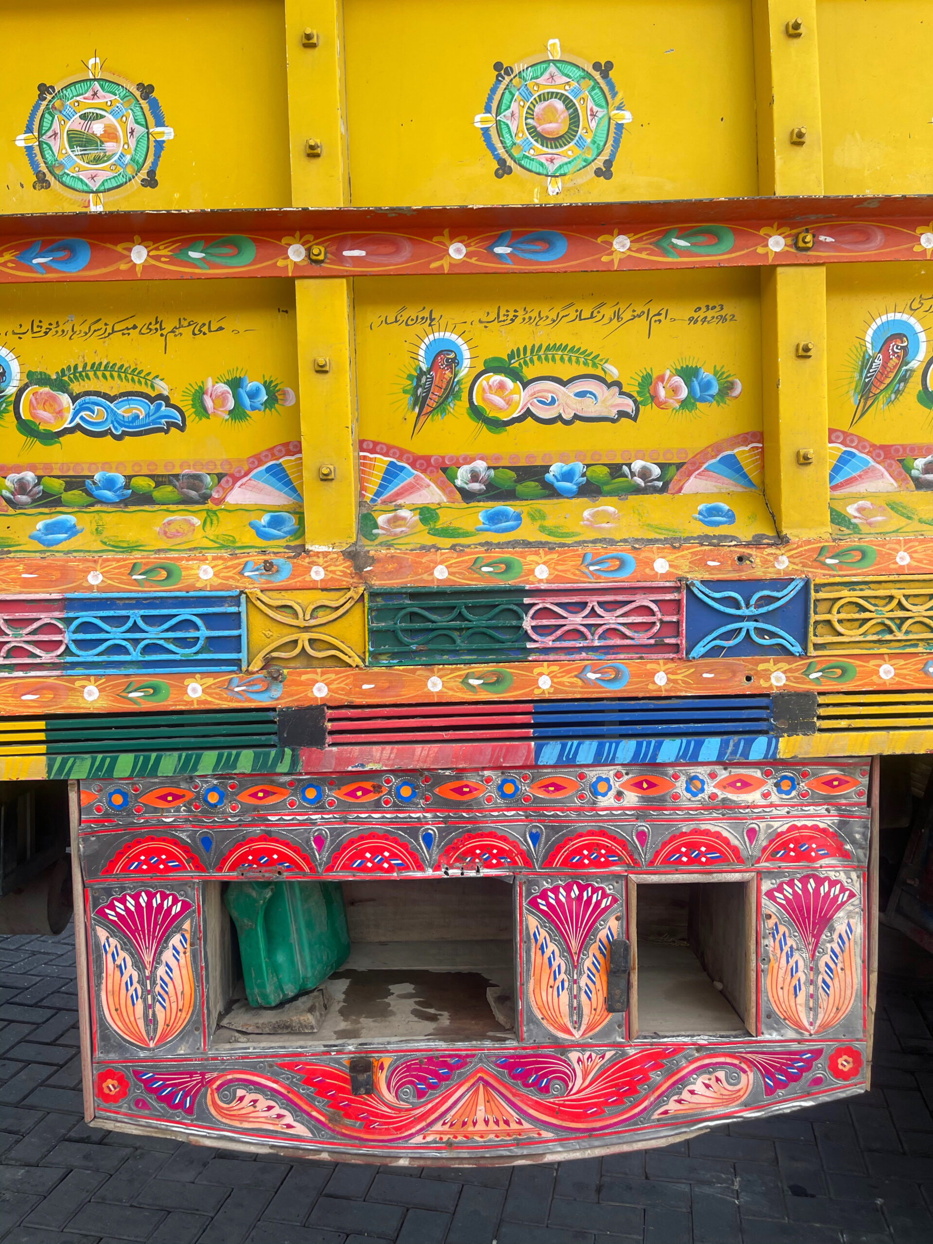 close of of truck showing the hand painted motifs of birds and flowers