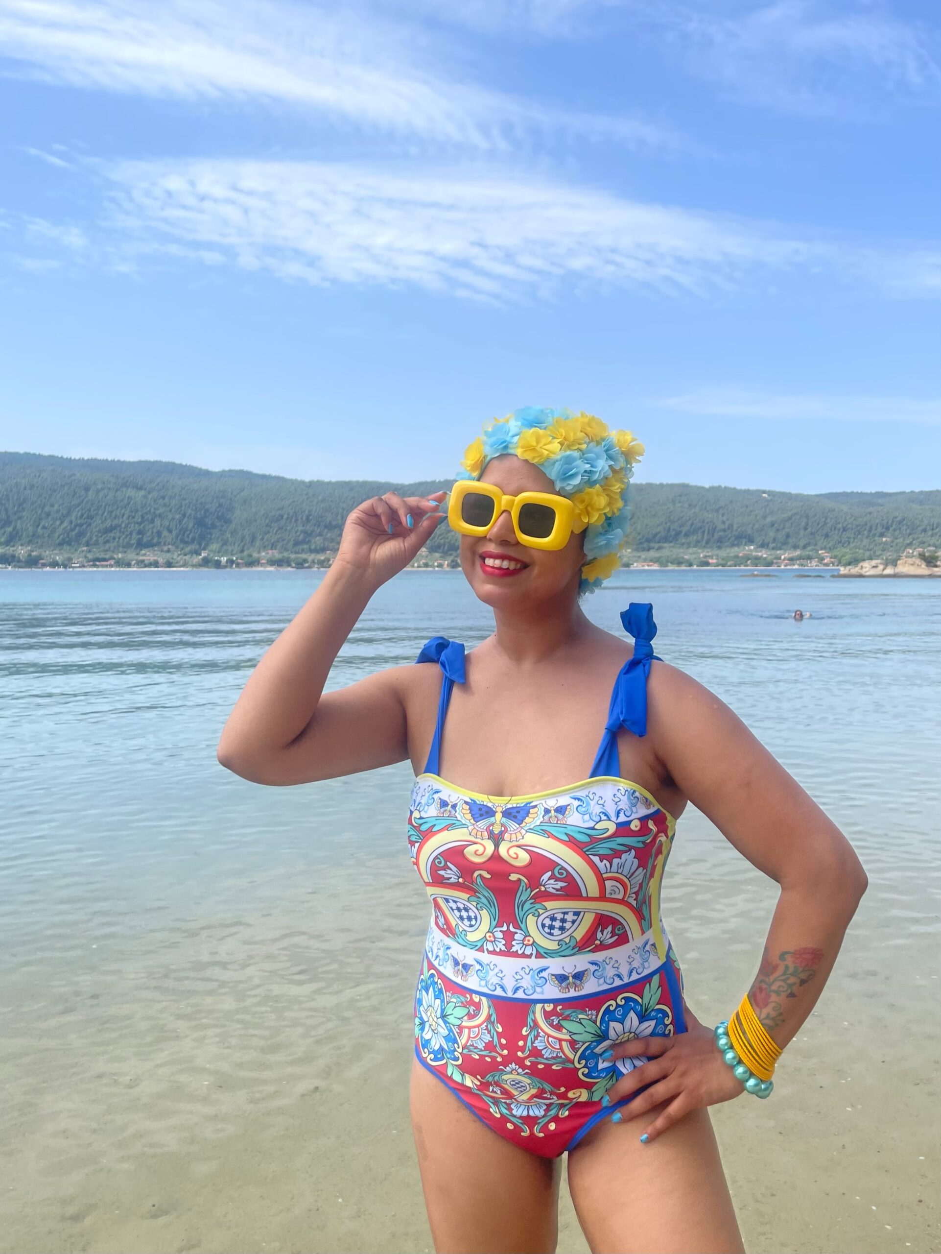 happy girl on beach in fake gucci print swimsuit