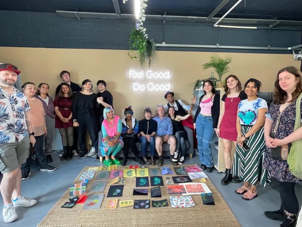 group of adults standing around by the artwork that created