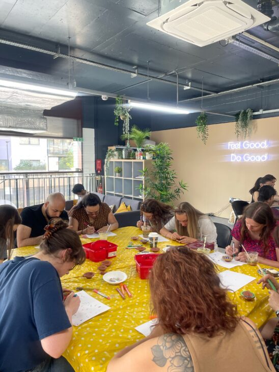 a busy table of people crafting