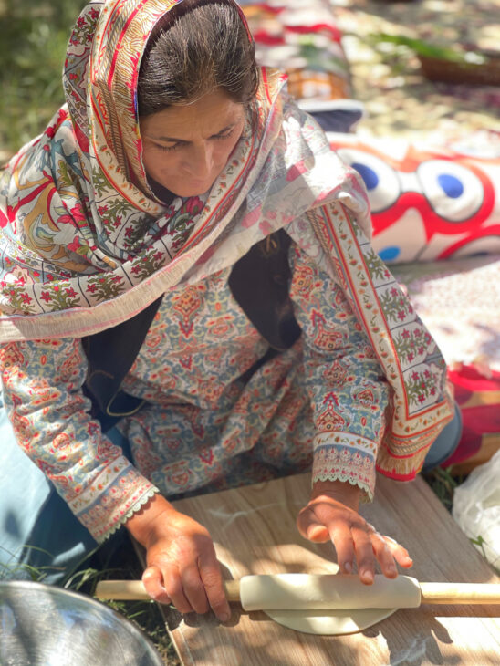 cookery class tutor wearing traditional block printed clothes and rolling dough